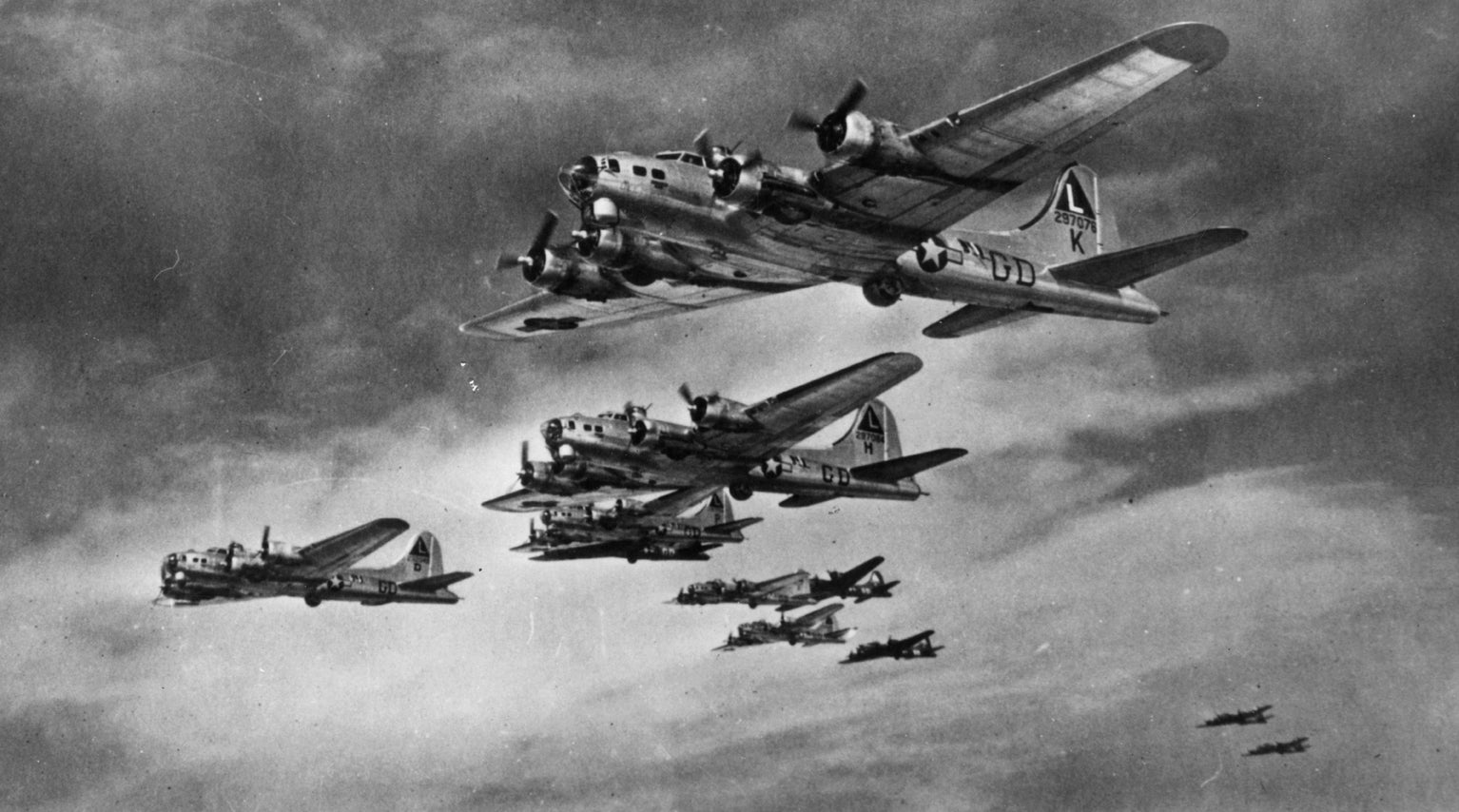 B-17 Flying Fortresses of the 381st Bomb Group fly in formation.