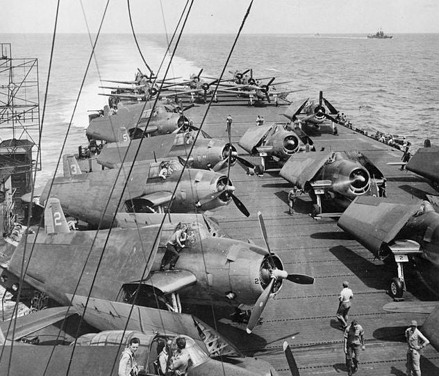 U.S. Navy Grumman TBM-3 Avenger torpedo bombers and Grumman F6F Hellcat fighters (right and aft) of Carrier Air Group 50 (CVLG-50) on the deck of the light aircraft carrier USS Bataan (CVL-29) in 1944.