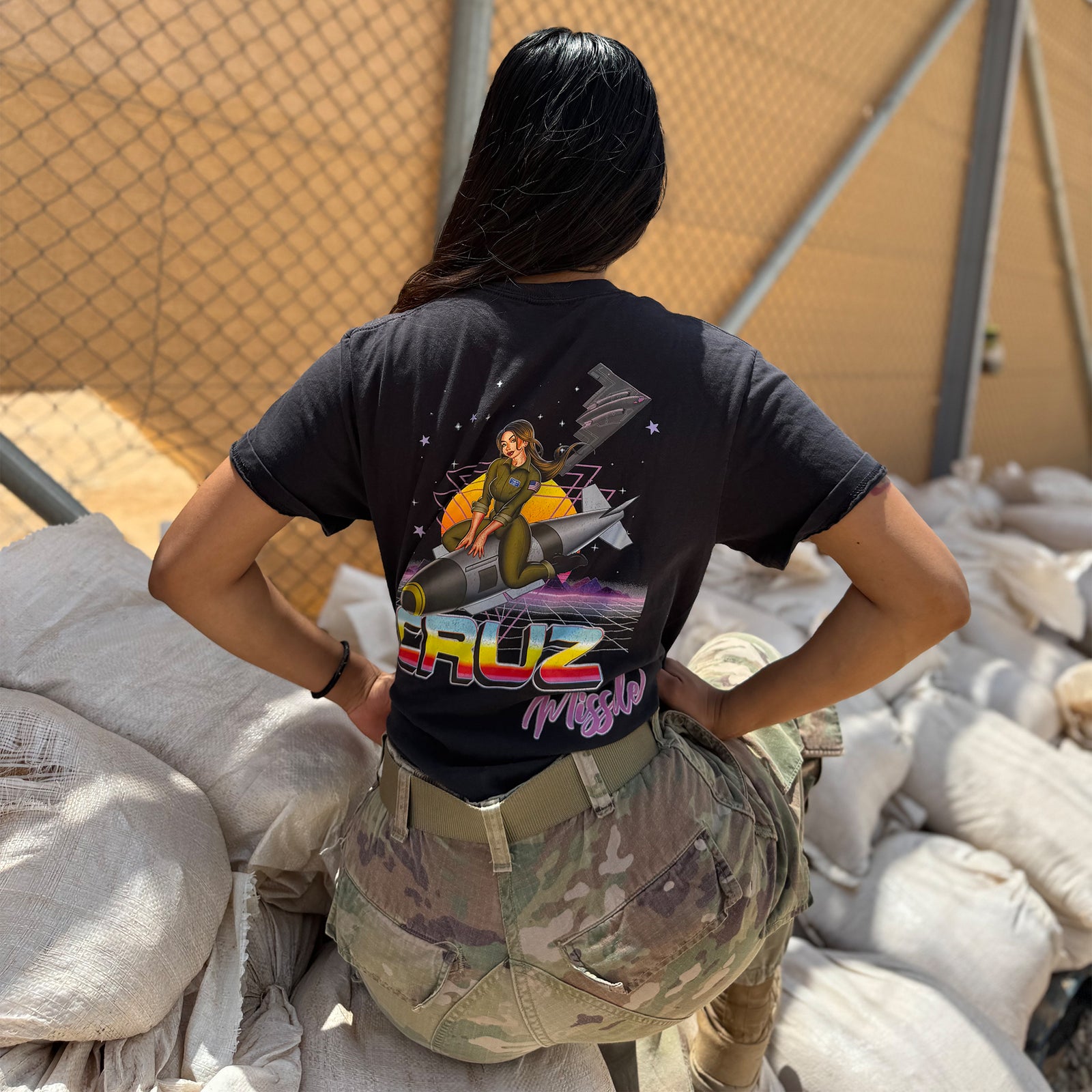 B-2 Spirit Cruz Missile Retrowave Air Force Pin-Up Girl Judy Operation Epic Fury graphic t-shirt with stealth bomber and retro neon background lifestyle shot v3