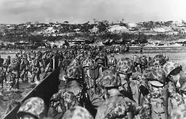 The 6th Marine Division wade ashore to support the beachhead on Okinawa, 1 April 1945.