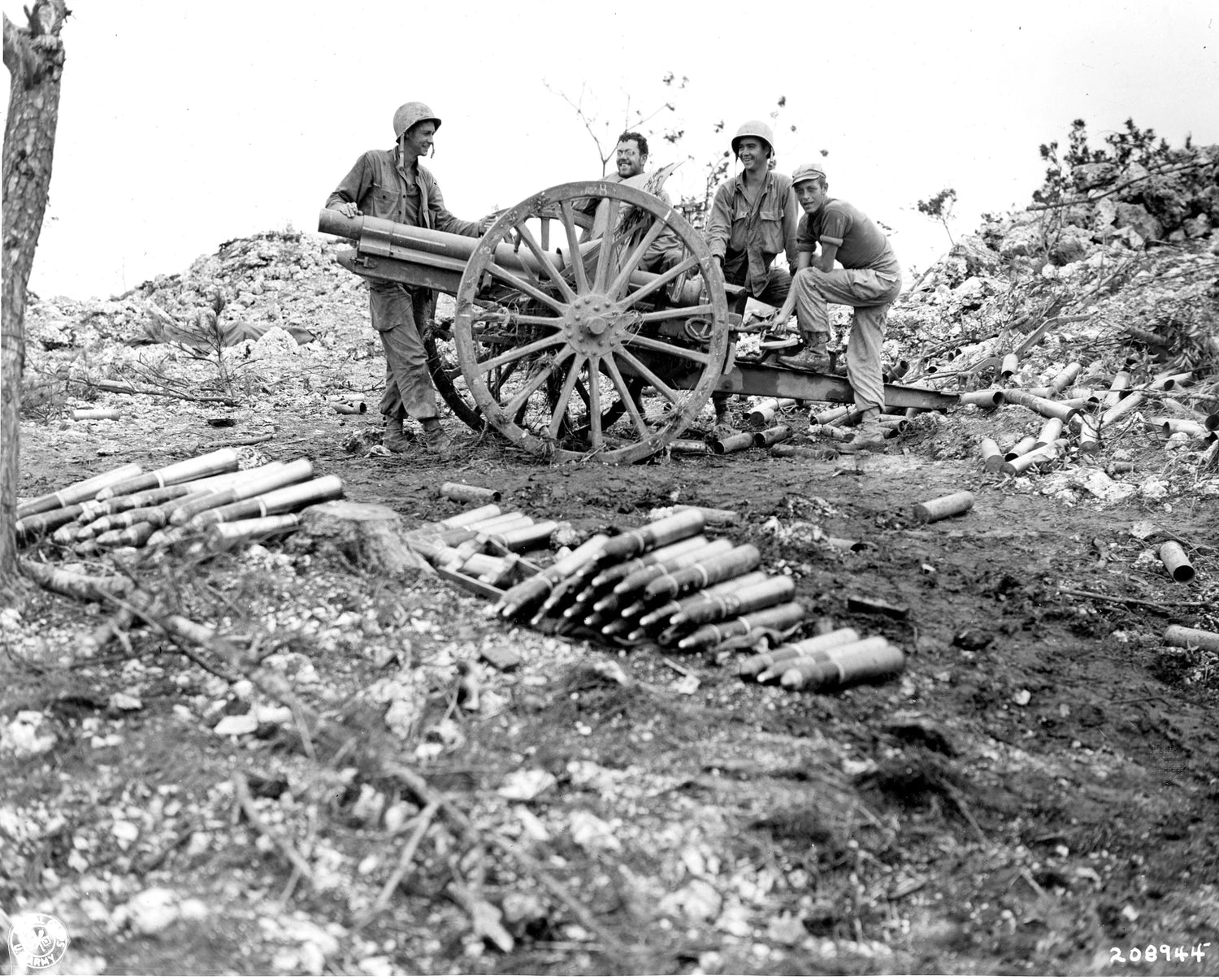 Men of Co. B, 184th Inf. Regt., inspect a Japanese 75-mm gun they captured on Okinawa. 29 May 1945.