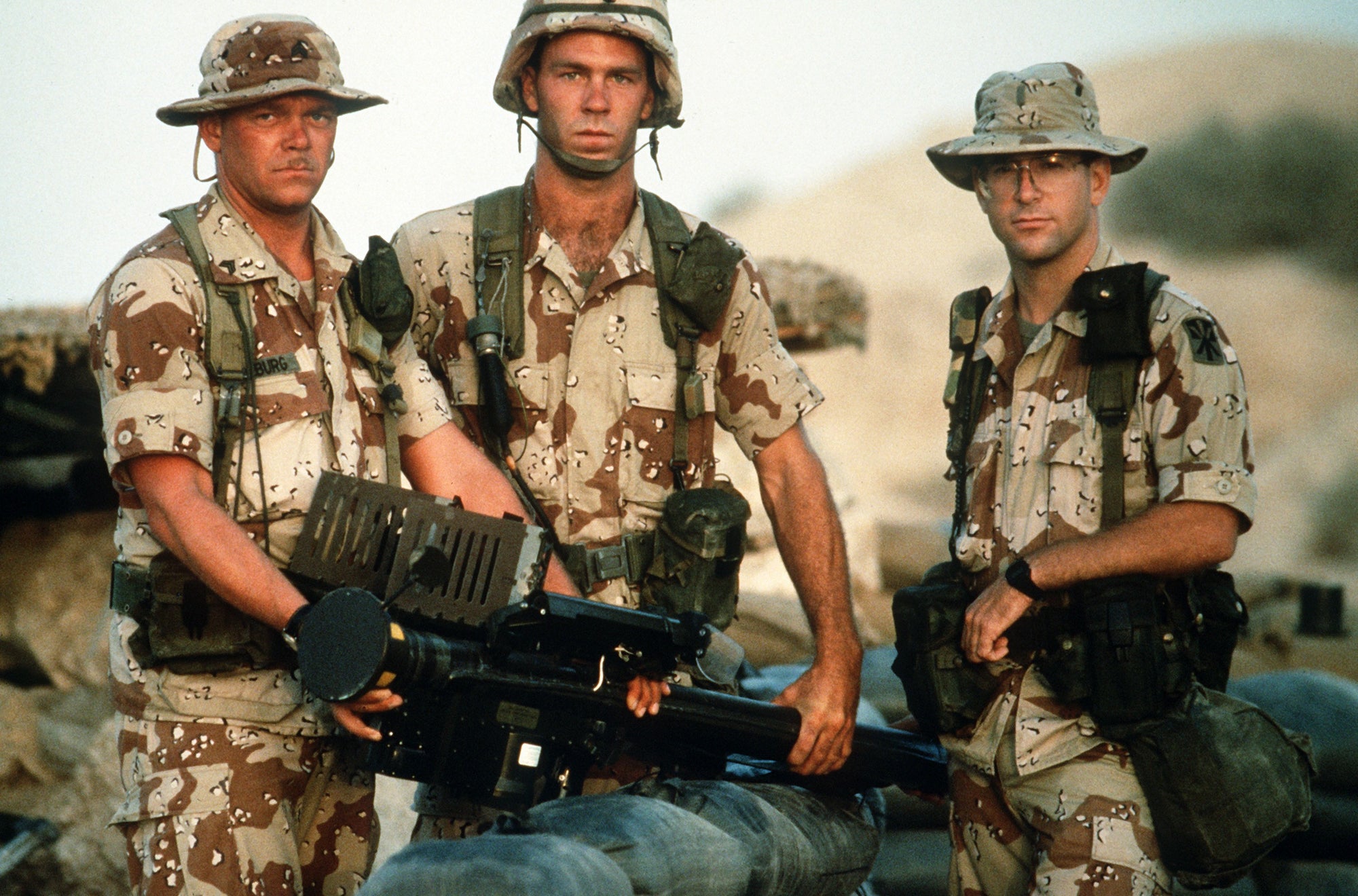 US Army soldiers posing for a photo during Operation Desert Storm, representing Tactically Acquired Gulf War merchandise collection.